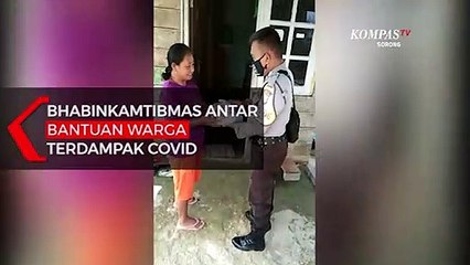 Bhabinkamtibmas Antar Bantuan Warga Terdampak Covid