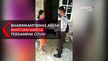 Bhabinkamtibmas Antar Bantuan Warga Terdampak Covid