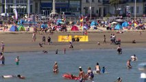 Britons head to the beach on the hottest day of the year so far