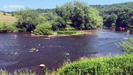 Britons cool off along the River Wye on hottest day of the year