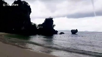 Scary grey waterspout sweeps across ocean in southern Thailand