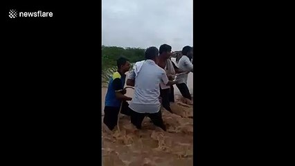 Heartstopping moment Indian villagers throw rope to save man drowning in flood