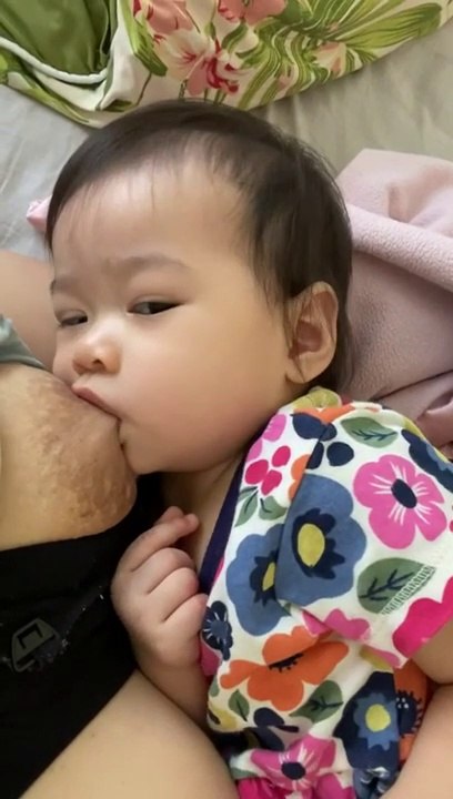 Mother feeding milk her baby