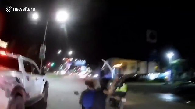 Police chase motorcycle rider and passenger waving a Samurai sword in Cambodia