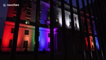 Pride flag made out of colorful floodlights illuminates building in Toronto