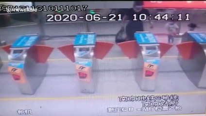 Chinese girl knocked over by ticket machine gates at train station