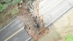 Massive sinkhole swallows road during flooding