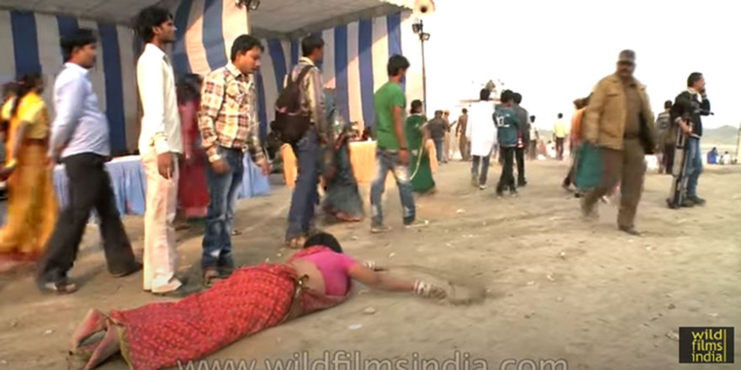 Female devotee crawls towards ghat during Chatt Puja