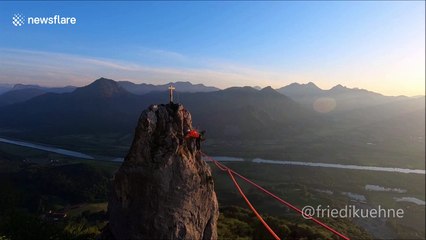 German daredevil bounces back and forth on highline above Bavarian Alps