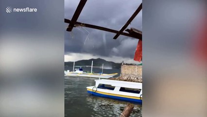 Waterspout sweeps through beach harbour in the Philippines