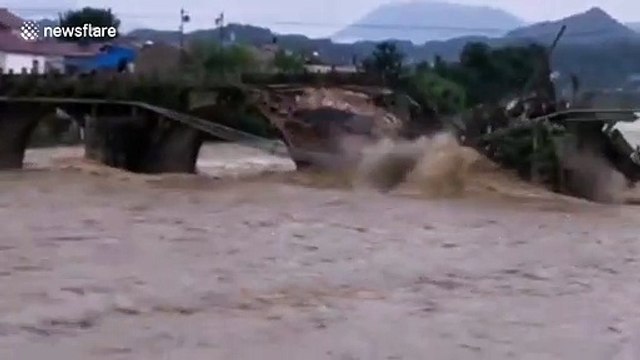 Bridge dating back 400 years washed away by overflowing river during floods in China