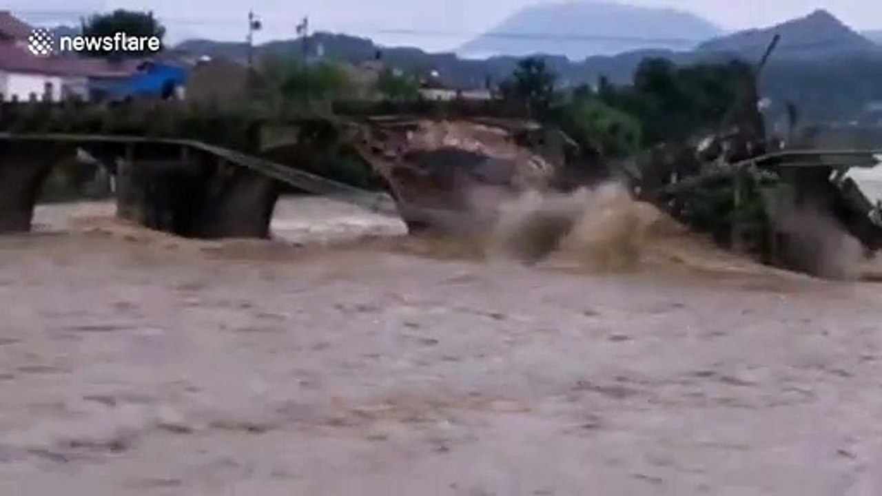 Bridge dating back 400 years washed away by overflowing river during floods in China