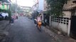 Cyclist rides with pet chicken on shoulder