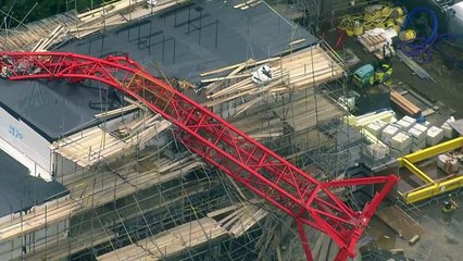 Crane crashes into homes in east London