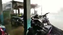Storm tears off roofs and blows over trees in Indonesia