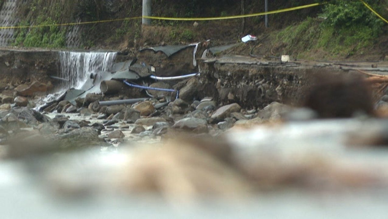 Heavy rain and flooding cause damage to road