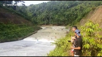 Dam-surfing daredevils at reservoir in Indonesia