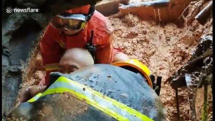 Firefighters rescue elderly man buried in mud after landslide hits southern China