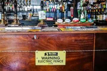 This British Pub Installed an Electric Fence in Front of the Bar to Encourage Social Dista