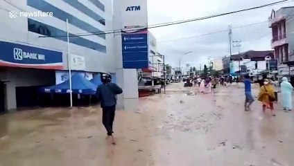 Homes entombed in mud as flash floods kill at least 16 people in Indonesia