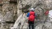 Mountaineers in the Dolomites scale cliff edge for breathtaking views