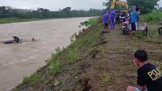 Villagers try to save truck washed away by river in the Philippines