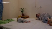 Mum copies her toddler's movements while laying in bed