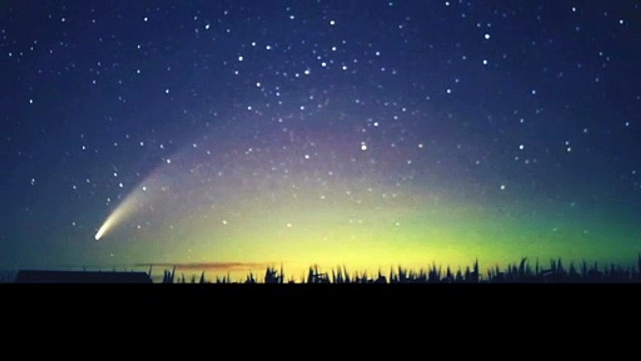 Comet Drifts Though Northern Lights