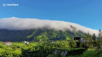 Breathtaking moment clouds flow over mountaintop in Thailand