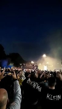 Leeds United on top of open top bus outside Elland Road