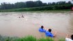 Chinese villagers venture in floodwater to rescue driver of submerged car