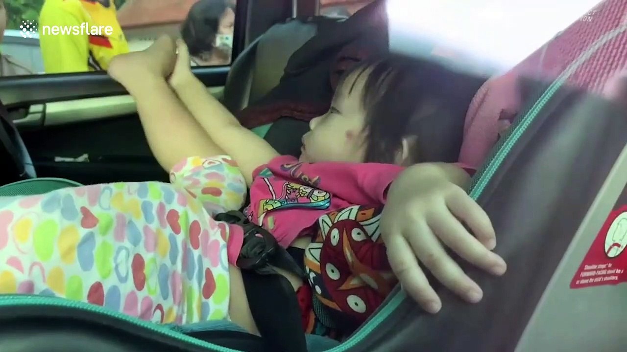 Firemen rescue two girls accidentally locked inside car with engine running