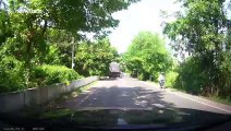 Heart-stopping moment cyclist is inches from being crushed by overtaking truck