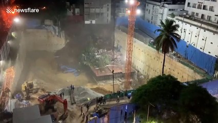 Three-storey building crashes down into construction pit in southern India