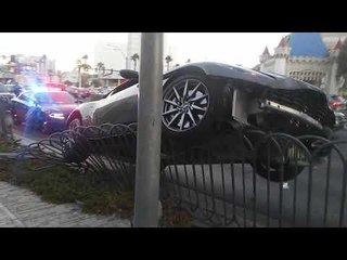 Sports Car Crashes and Gets Hung on Fence in Las Vegas