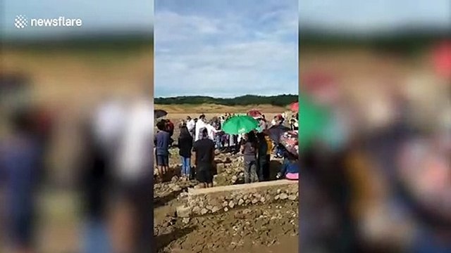 Villagers attend mass at sunken church that has reappeared during drought in the Philippines