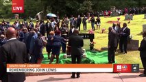 Roses placed on John Lewis' casket at cemetery, doves released