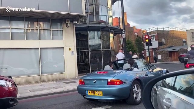 Arsenal fans on Holloway Road celebrate winning FA Cup by waving flags out of cars and beeping horns