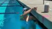 Watch Olympic swimmer Katie Ledecky swim the entire length of a pool with a glass on her head