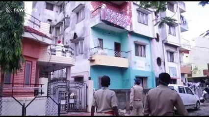 Shocking moment Indian woman threatened to jump off high ledge after alleged family dispute
