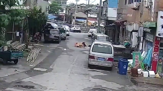 Chinese children playing in cardboard boxes luckily survive being run over by car