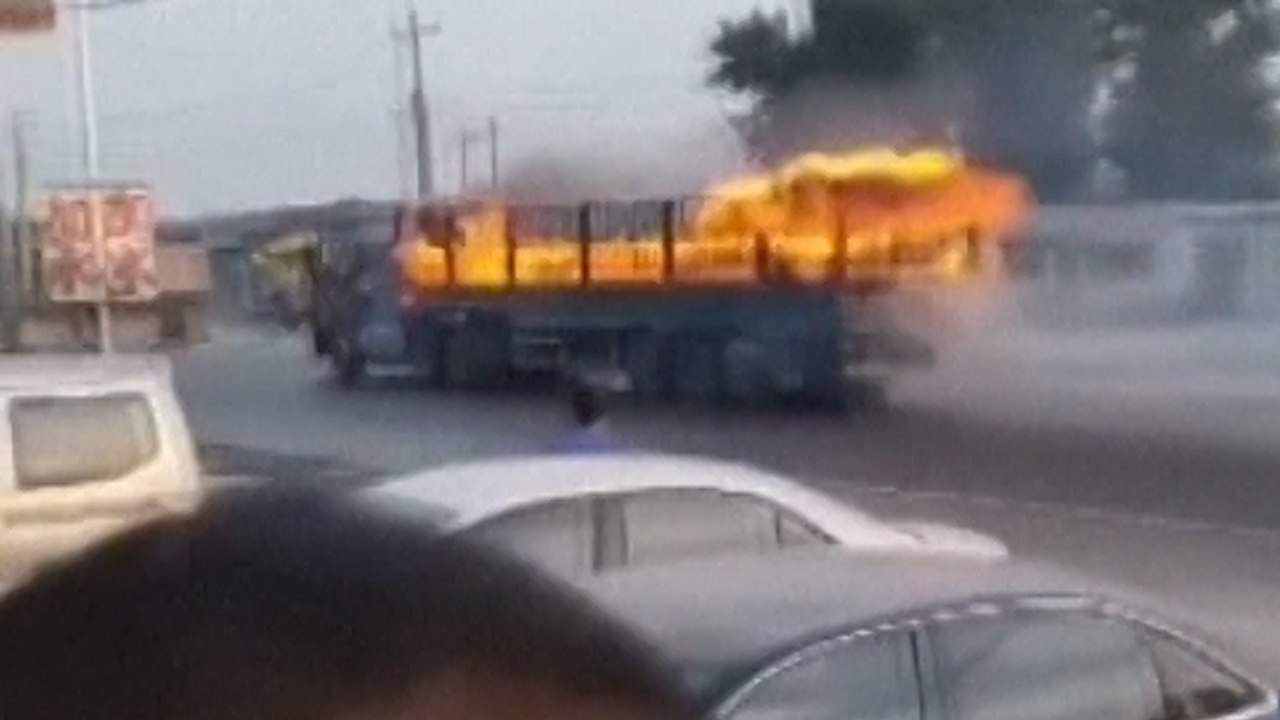 Heroic Chinese driver steers his burning truck...