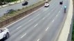 Chinese men sit on car roof as it drives along road