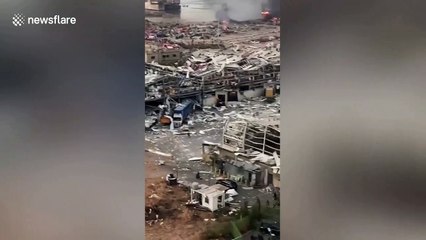 People seen running as sirens wale in the immediate aftermath of the Beirut blast