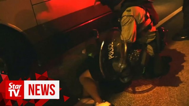 HK police fire tear gas to counter brick-throwing protesters