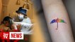 Hong Kong artist offers free protest-themed tattoos