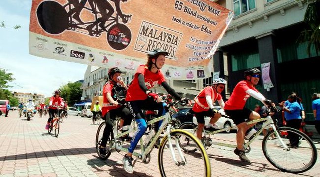 Visually-impaired cyclists ride their way into record book