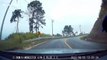 Motorcycle rider crashes and skids towards oncoming car while frantically trying to avoid being hit