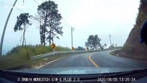 Motorcycle rider crashes and skids towards oncoming car while frantically trying to avoid being hit