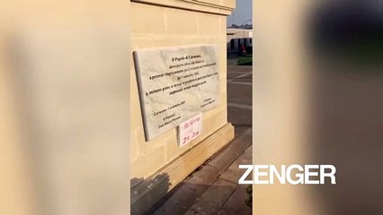 People stand at base of Virgin Mary statue as "bloody tear" falls from eye